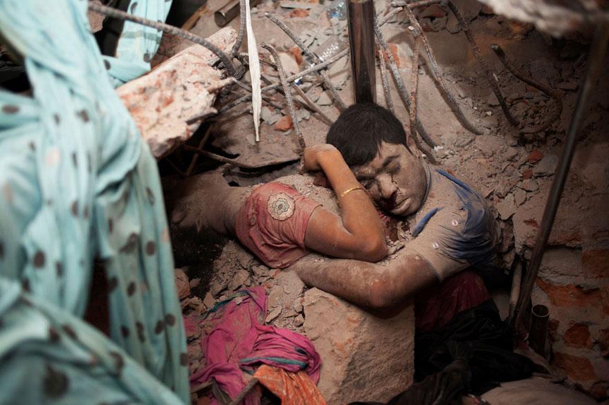 Embracing couple in the rubble of a collapsed factory