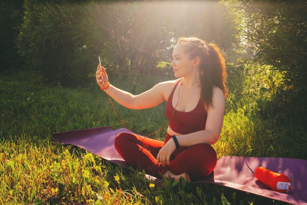 young beautiful woman in red leggings and a top practicing yoga