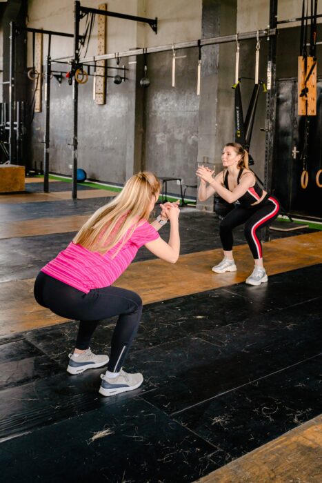 Chair squat is one of the exercises to do in the office for better posture