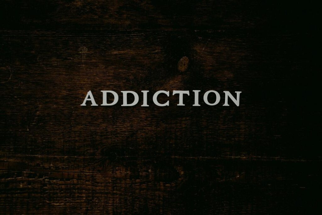 The word ADDICTION on a black background.