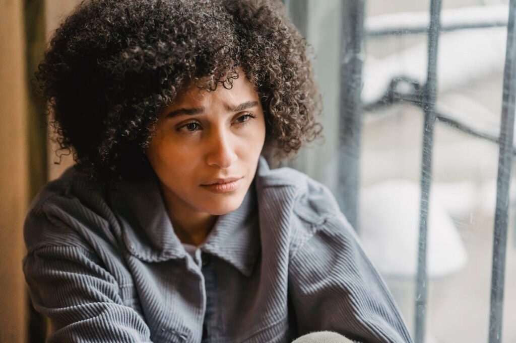 Woman reflecting by the window during depression recovery